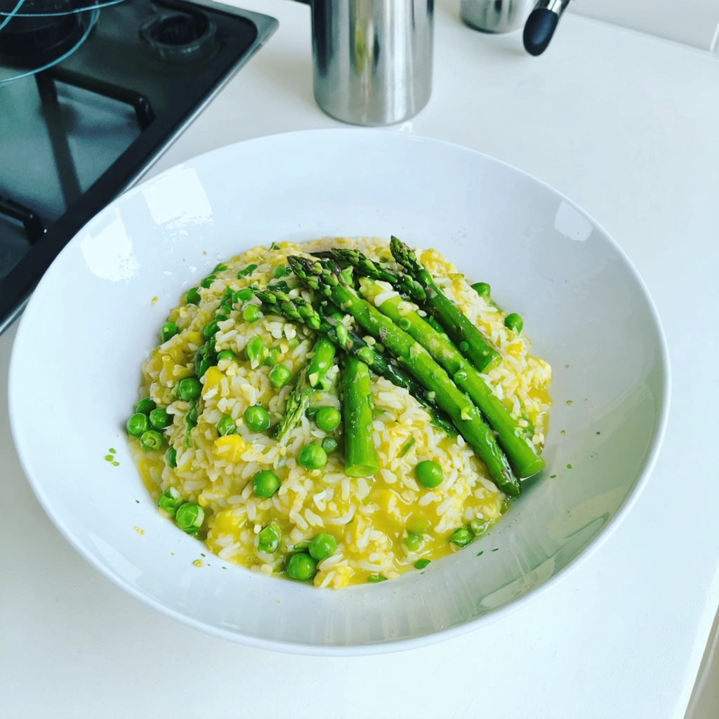 A bowl of rice with peas and asparagus.